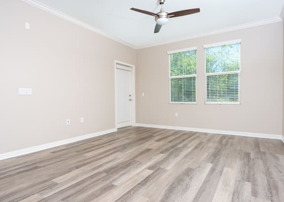 a bedroom with hardwood floors and a ceiling fan