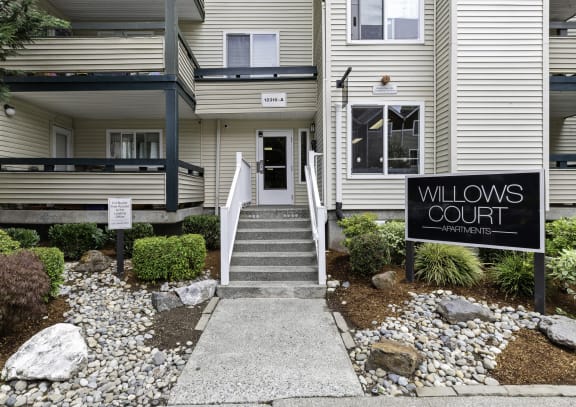 a building with a sign that reads willows court at Willows Court Apartment Homes, Seattle
