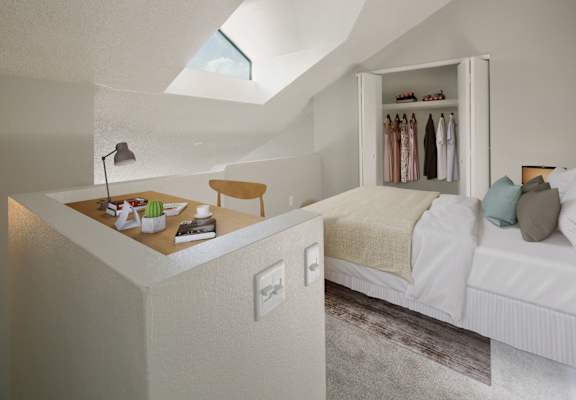 a bedroom with a bed and a counter with a desk