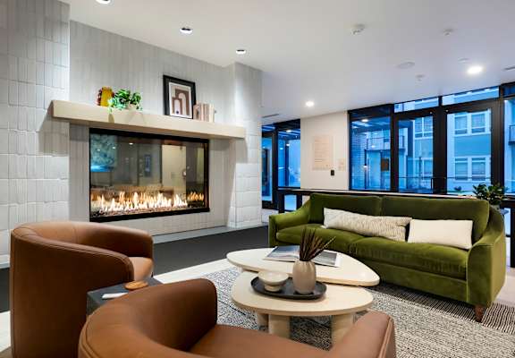 A modern living room with a fireplace and comfortable seating.