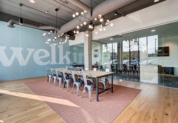 a large open space with a long wooden table and chairs