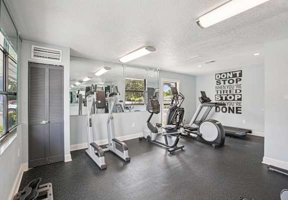 A gym with a sign that says "Don't stop when you're tired, you're done.".