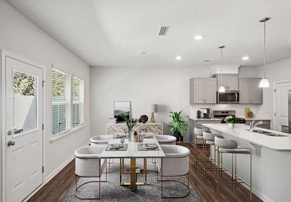 an open kitchen and dining room with a table and chairs