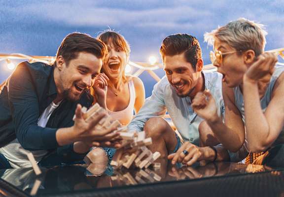 Four people playing a board game together.