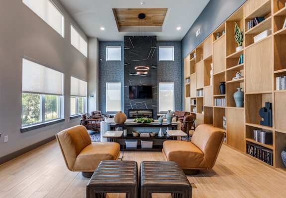 A modern living room with a fireplace and a large window.