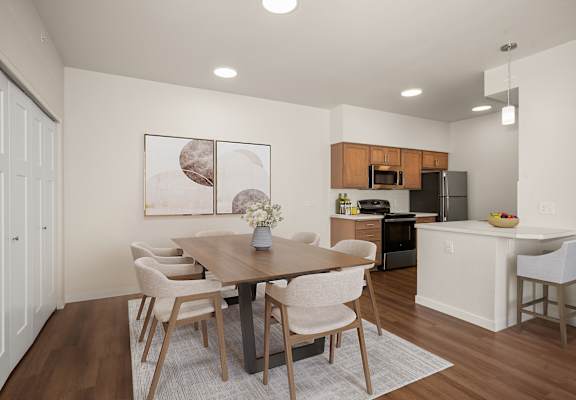 A modern dining room with a wooden table and chairs.