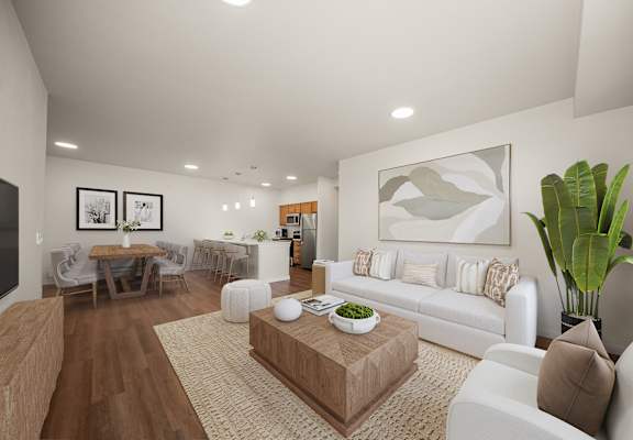 A living room with a white couch, a coffee table, and a dining table with chairs.