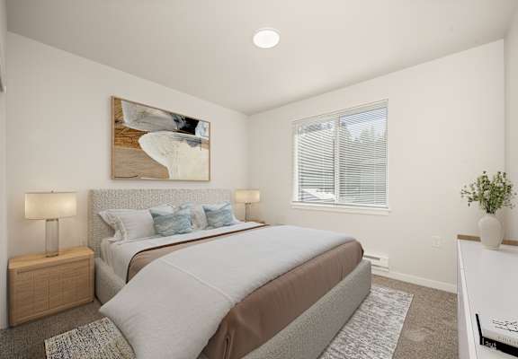 A bedroom with a large bed and a painting on the wall.