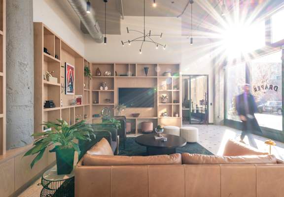 a living room with couches and chairs and a large window