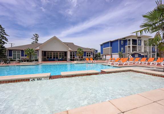 A swimming pool with a building in the background.