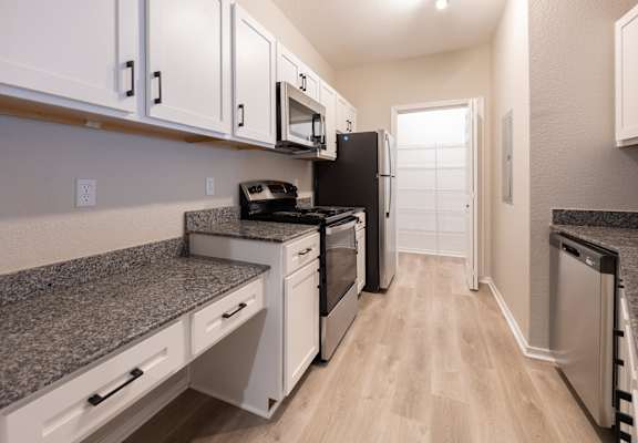 Kitchen with granite counter tops and stainless appliances