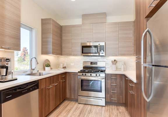 a kitchen with stainless steel appliances and wooden cabinets