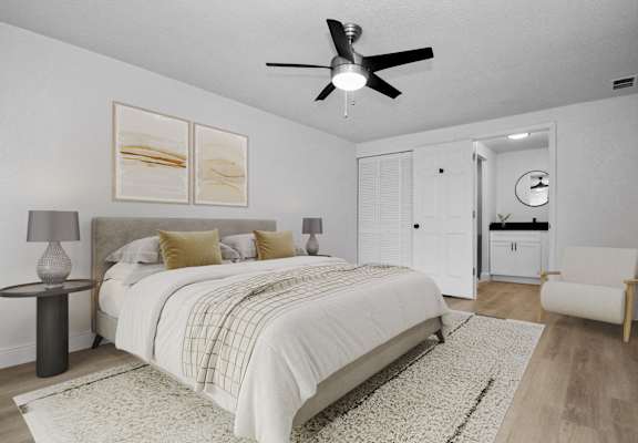 a bedroom with a large bed and a ceiling fan