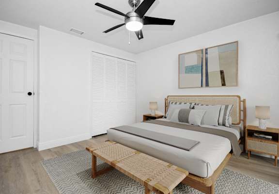 a bedroom with a bed and a ceiling fan