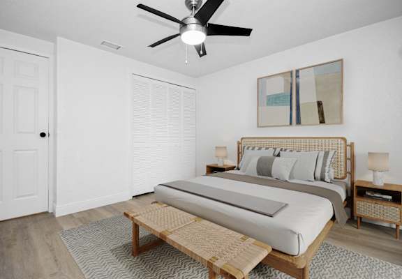 a bedroom with a bed and a ceiling fan