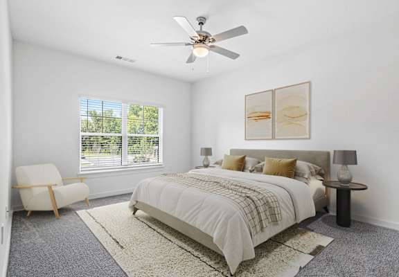 a bedroom with a bed and a ceiling fan