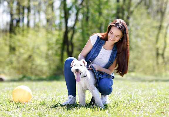 a woman and her dog in a park