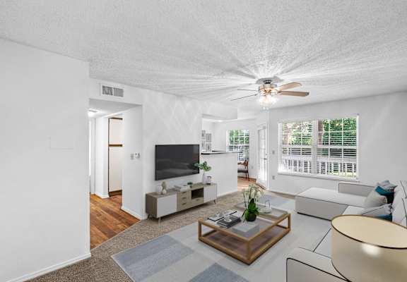 A living room with a white ceiling and a television.