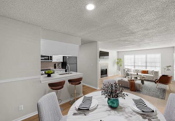 A modern kitchen with a dining table set for four.