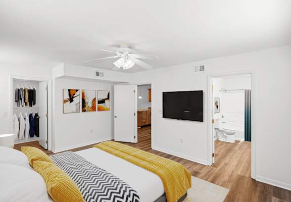 a bedroom with a bed and a ceiling fan