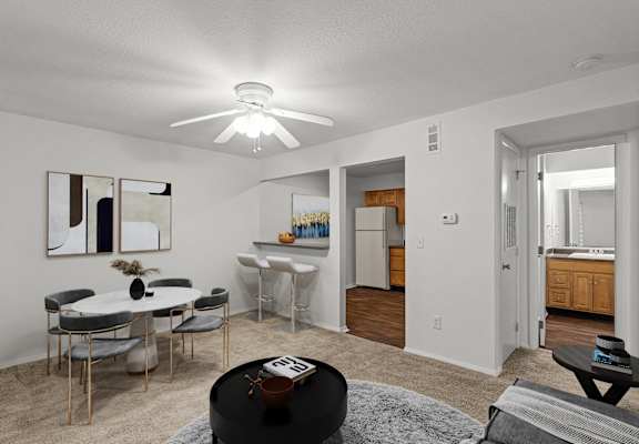 A living room with a dining table and chairs.
