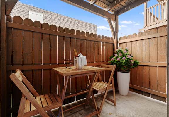 a small patio with a table and two chairs