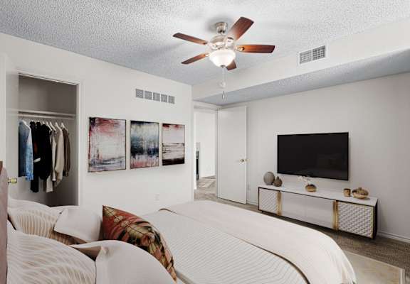A bedroom with a bed, a television, and a wardrobe.