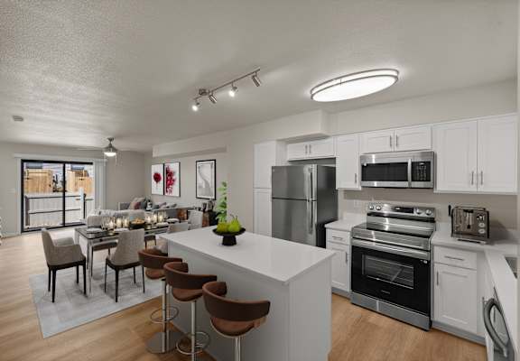 A modern kitchen with a large island and stainless steel appliances.