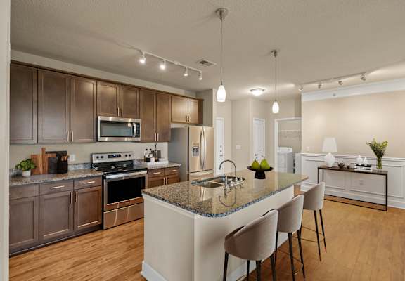 Kitchen with granite countertop and large island at The Residences at Bluhawk Apartments, Kansas, 66085
