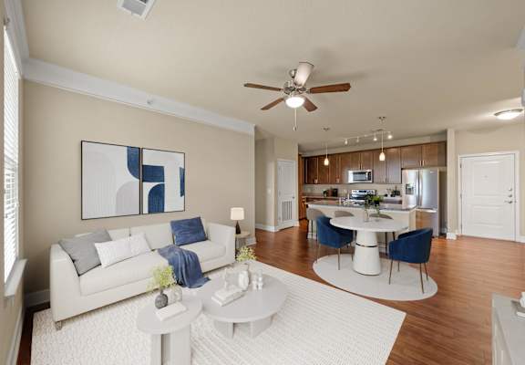 Living room with ceiling fan and light at The Residences at Bluhawk Apartments, Overland Park, Kansas