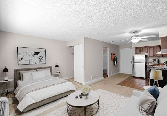 a bedroom with a large bed and a living room