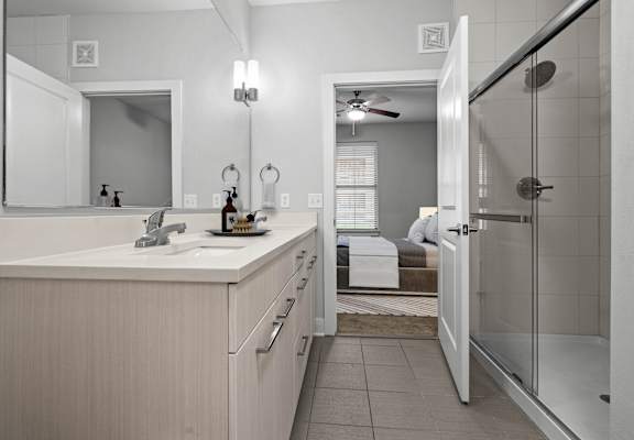 A bathroom with a white sink and a mirror above it.