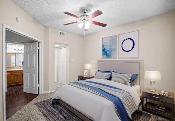 a bedroom with a bed and a ceiling fan