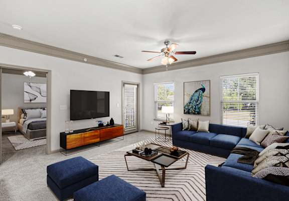 a living room filled with furniture and a flat screen tv