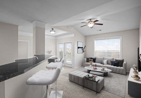 A modern living room with a black countertop and a white chair.