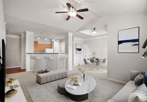 A modern living room with a grey sofa and a round coffee table.