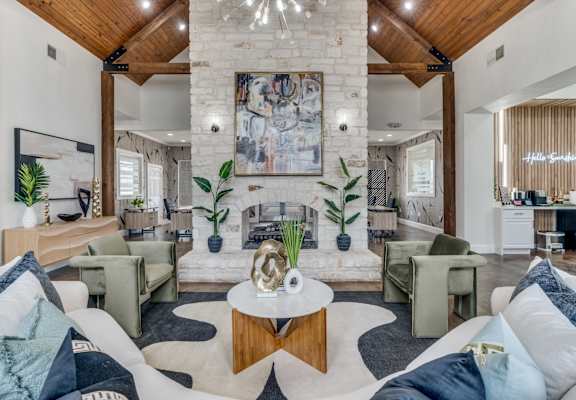 A living room with a fireplace and a painting on the wall.