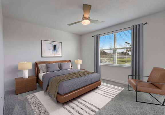 A bedroom with a bed, nightstands, and a chair.