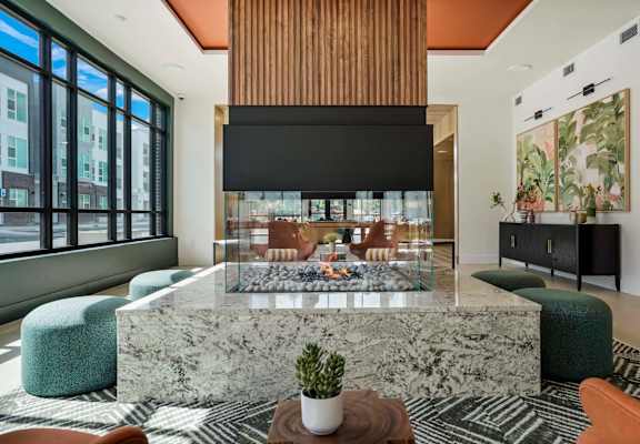 a living room with a marble table and a fireplace