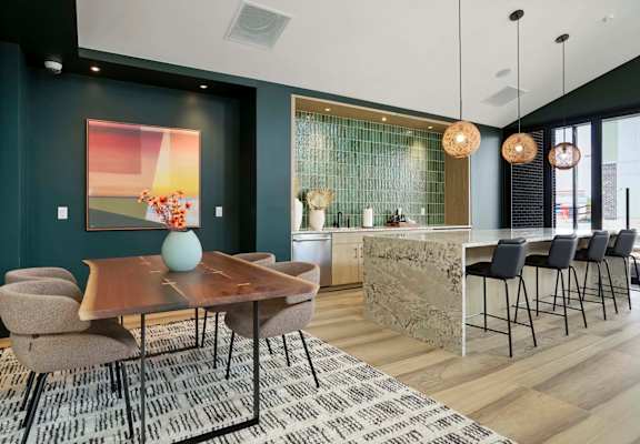 a dining room with a table and chairs and a kitchen