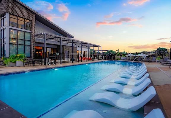 A long rectangular pool with white steps leading into it.