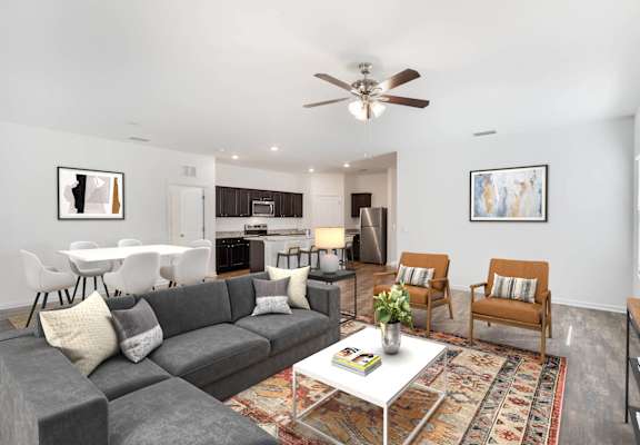A living room with a grey couch and a white coffee table.