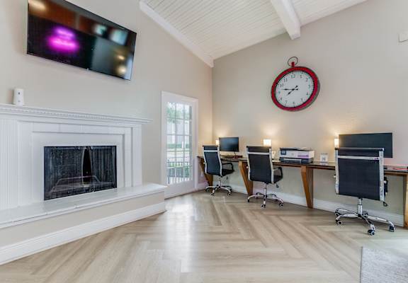 a home office with a fireplace and a clock on the wall at Falls on Clearwood Apartments, Richardson, TX, Texas