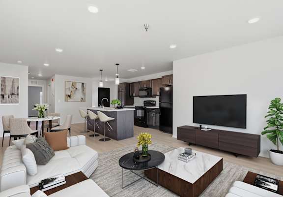 A modern living room with a white sofa, a black coffee table, and a flat-screen TV.