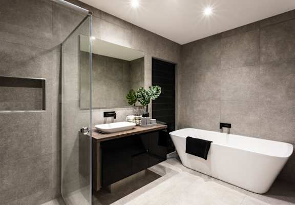 a bathroom with a tub and a sink and a shower