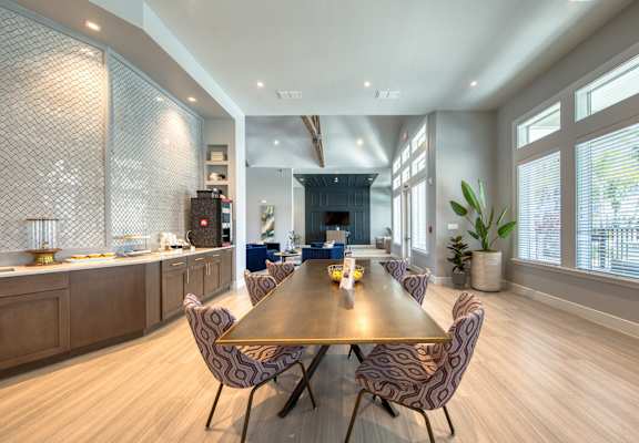 a dining room with a wooden table and chairs