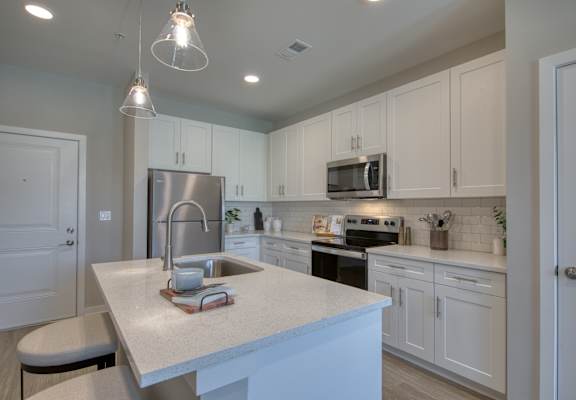 a kitchen with white cabinets and a white counter top