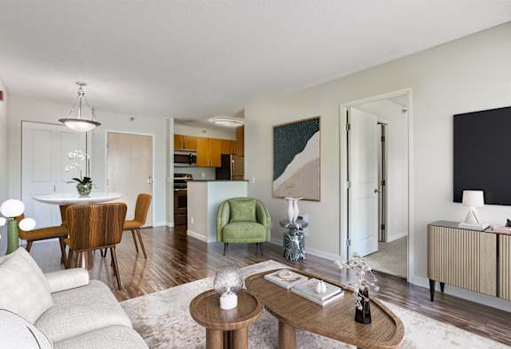 a living room and dining room with a table and chairs
