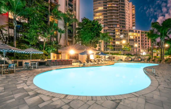 Apartments in San Diego CA - Resort Style Sparkling Pool at Lit on Cortez Hill Featuring Bar, Sundeck Lounge, and Various Pool Furniture at Vera Cortez Hill, San Diego, 92101