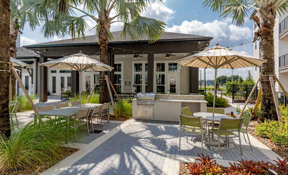 a patio with tables and umbrellas and a bar